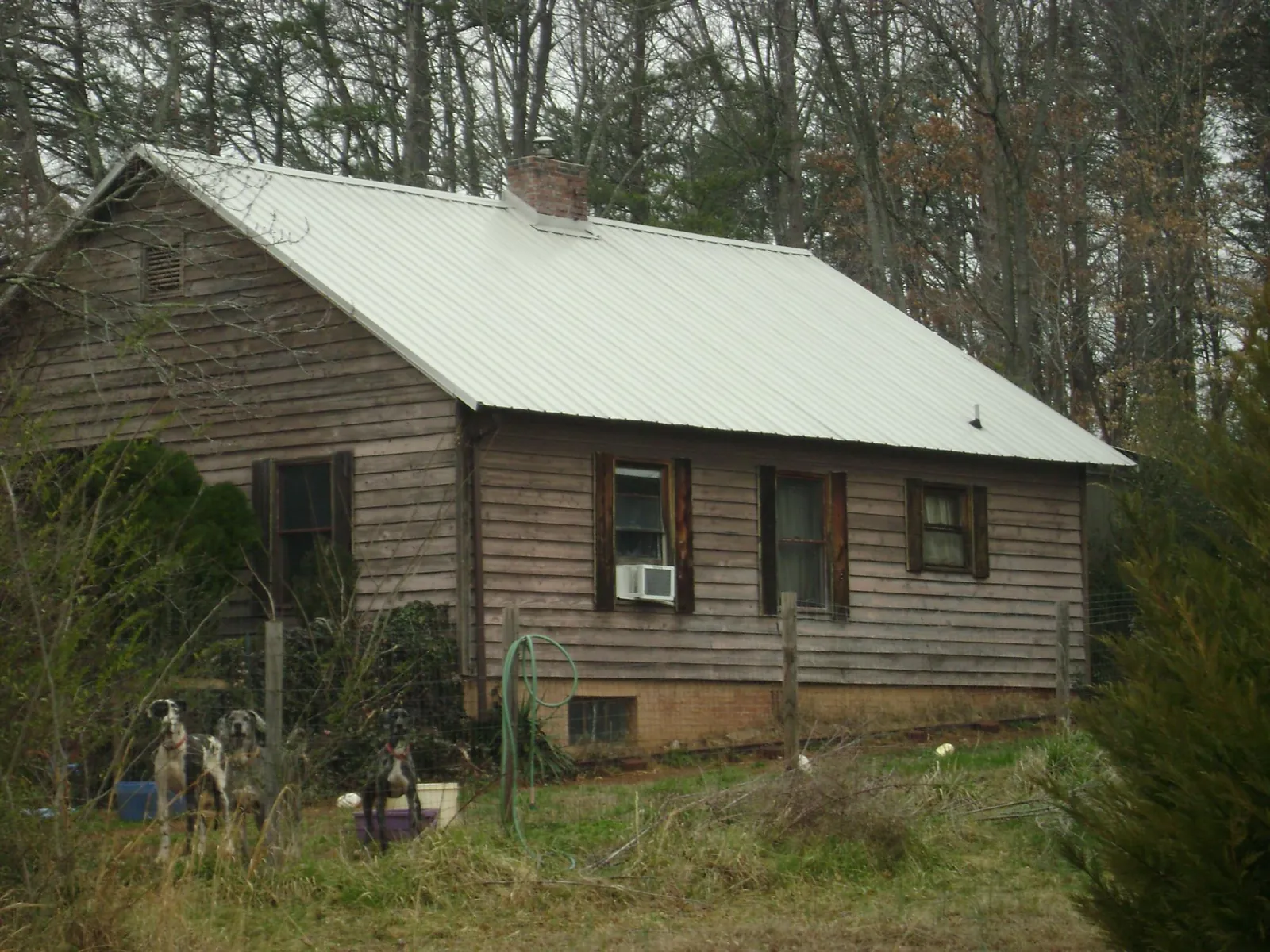 White metal roof on an old wood sided farmhouse, from a Asphalt Shingle Roof Repair job in Germantown